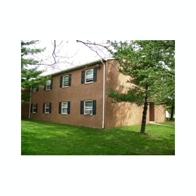 Two Story brick apartment building with multiple windows.